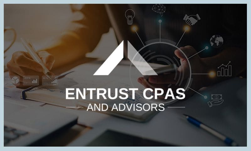 Entrust CPAs and Advisors logo over a desk with business charts